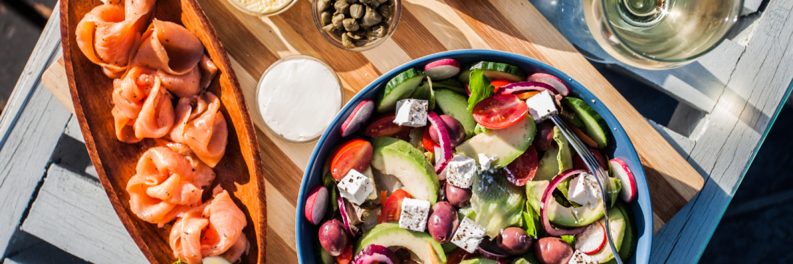 table set with a salad and raw salmon