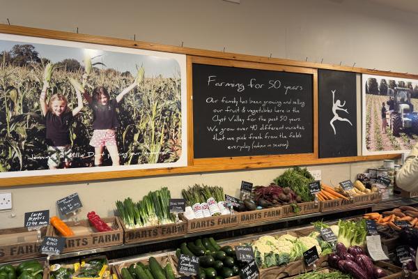 display of vegetables with farm signage for Dart's Farm in the background
