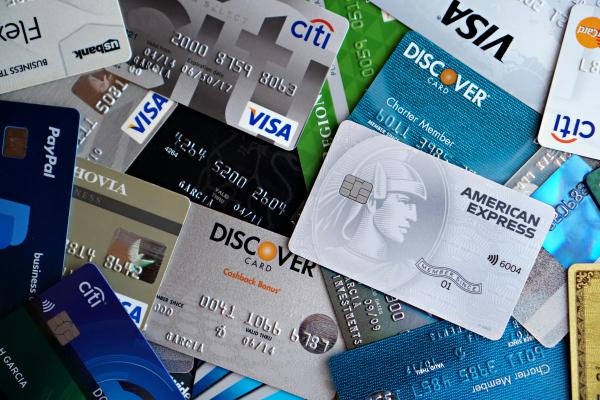 a pile of credit cards spread out on a flat surface