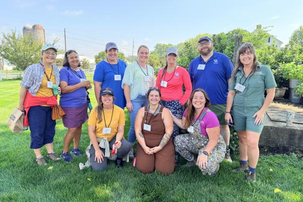 A group of people standing together at a cut flower farm