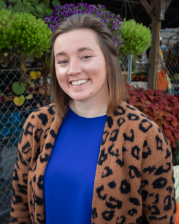 a woman in front of plants