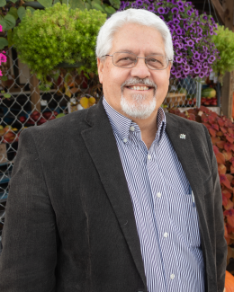 man standing in front of flowers