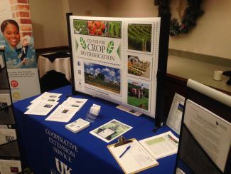 table with blue table cloth, graphical poster, and publications