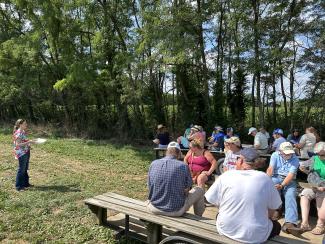 woman talking to group of people sitting on wagon