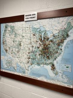 "Where are you from?" map with pushpins in farm store