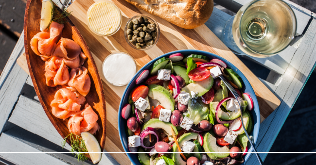 table set with a salad and raw salmon