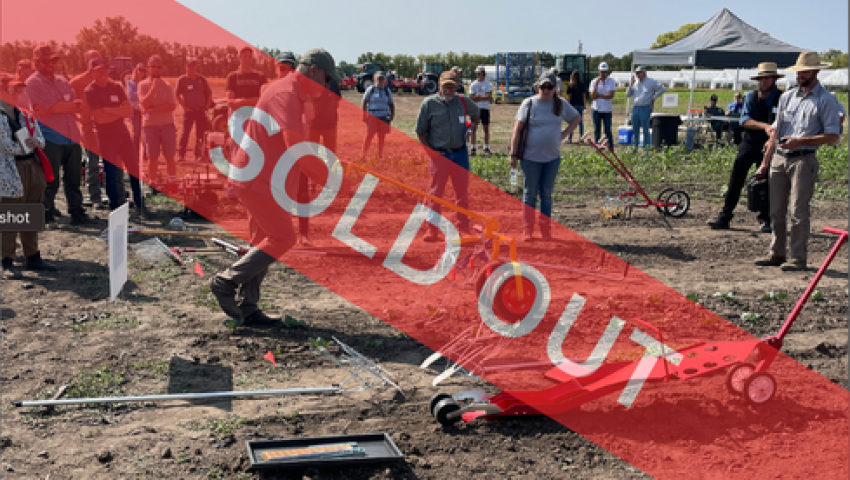 person pushing a small weeding implement with others watching. Banner overlay in read reading "sold out"