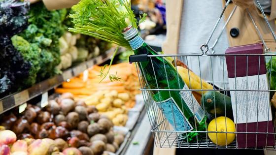 customer with basket at grocery store produce section