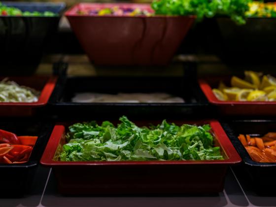 cafeteria salad bar  lettuce, tomato, onion