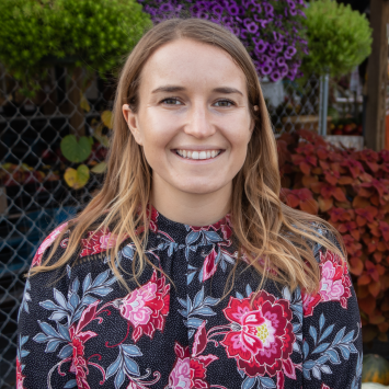 woman standing in front of flowers