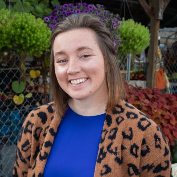 a woman in front of plants