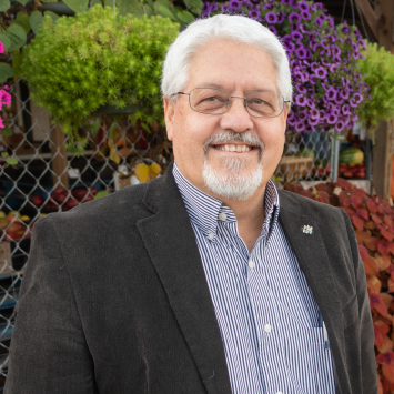 man standing in front of flowers