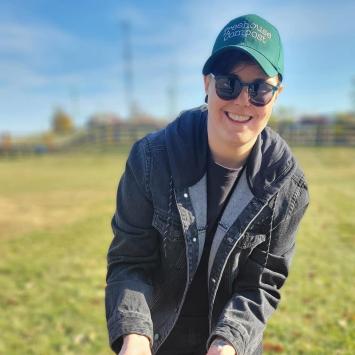 person standing over table with field in background