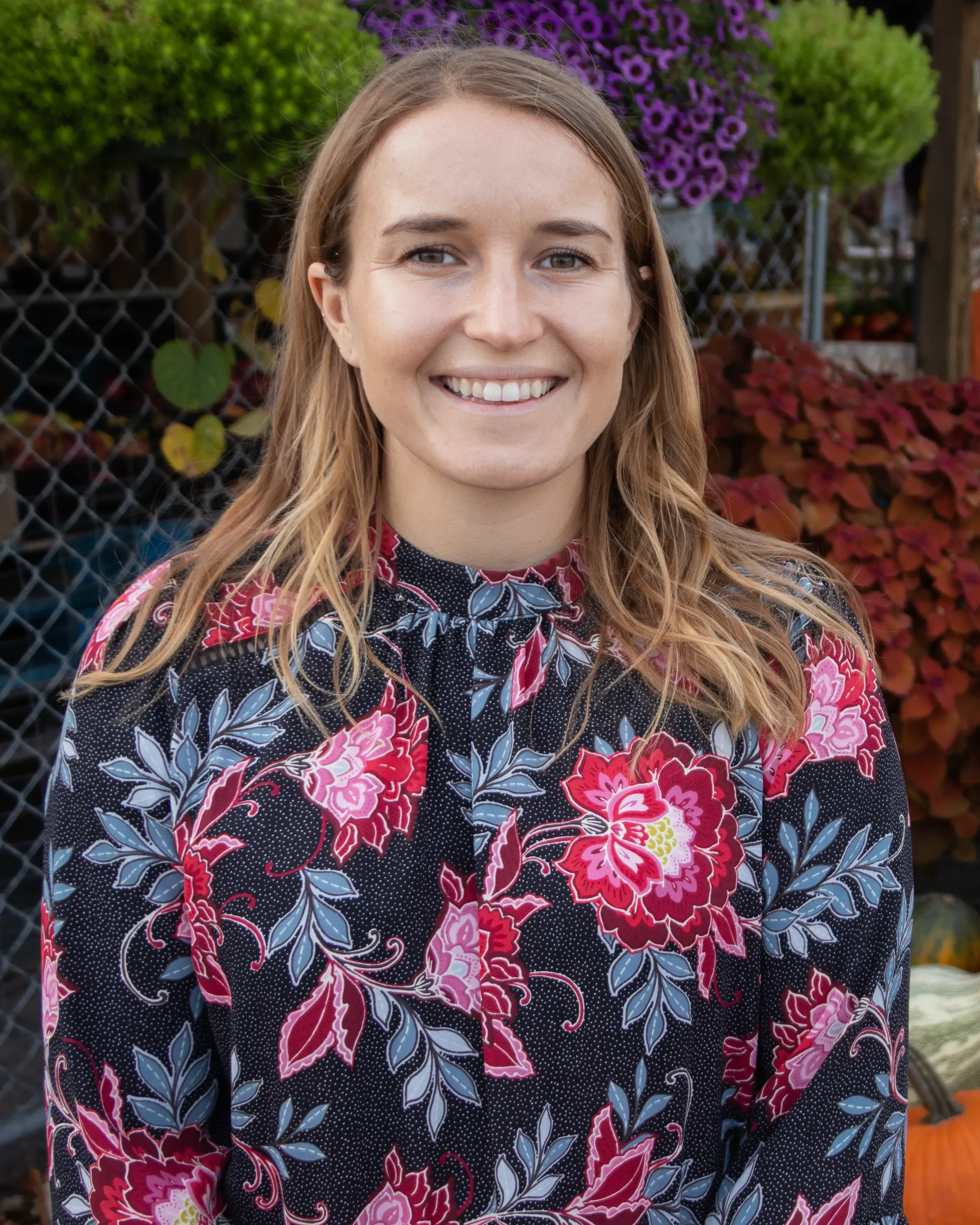 woman standing in front of flowers