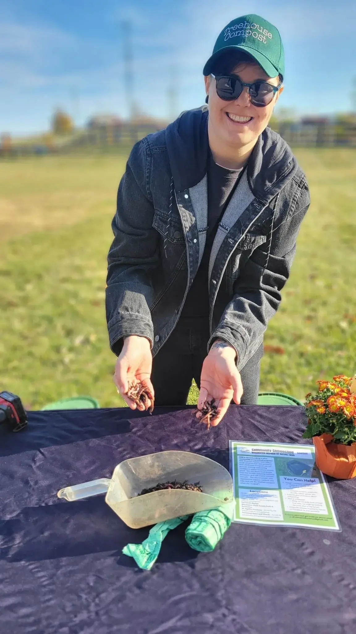 person standing over table with field in background